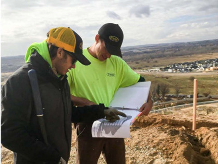 Two people working together on environmental permitting design